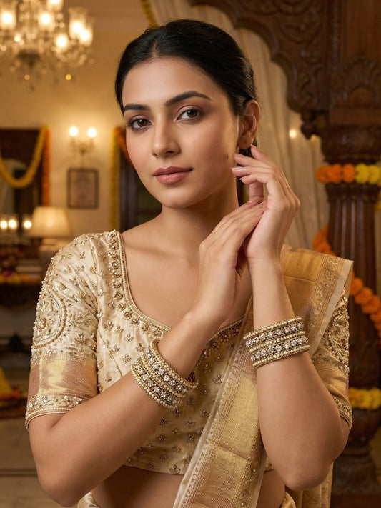 Ishhaara Elegant Golden Embroidered Saree Blouse - A woman wearing a golden embroidered saree blouse