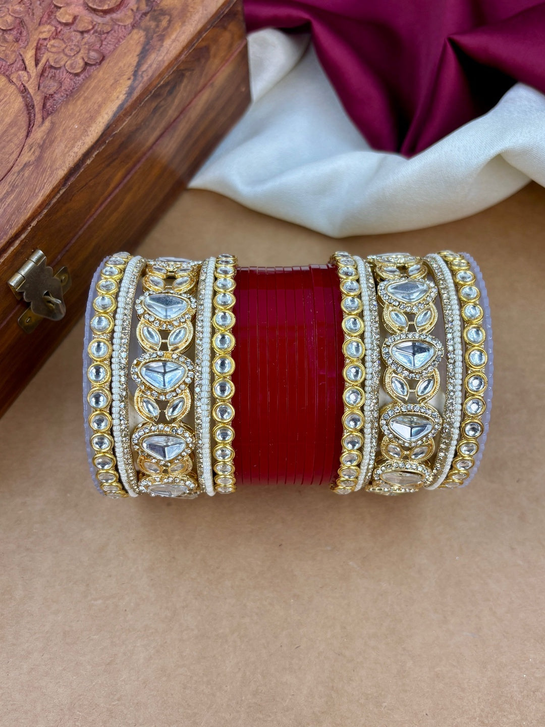 Ishhaara Embellished Kundan Bangle Set Red - A woman wearing a traditional Indian outfit with red and gold bangles - view 2