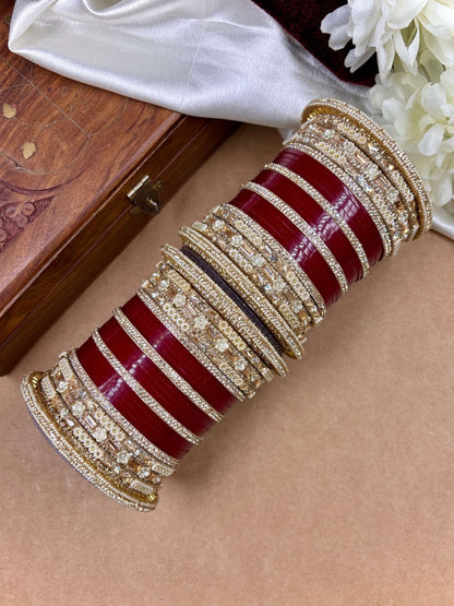 Ishhaara Embellished Red Kundan Bangles Set - a stack of red and gold bangles with diamond-cut stones