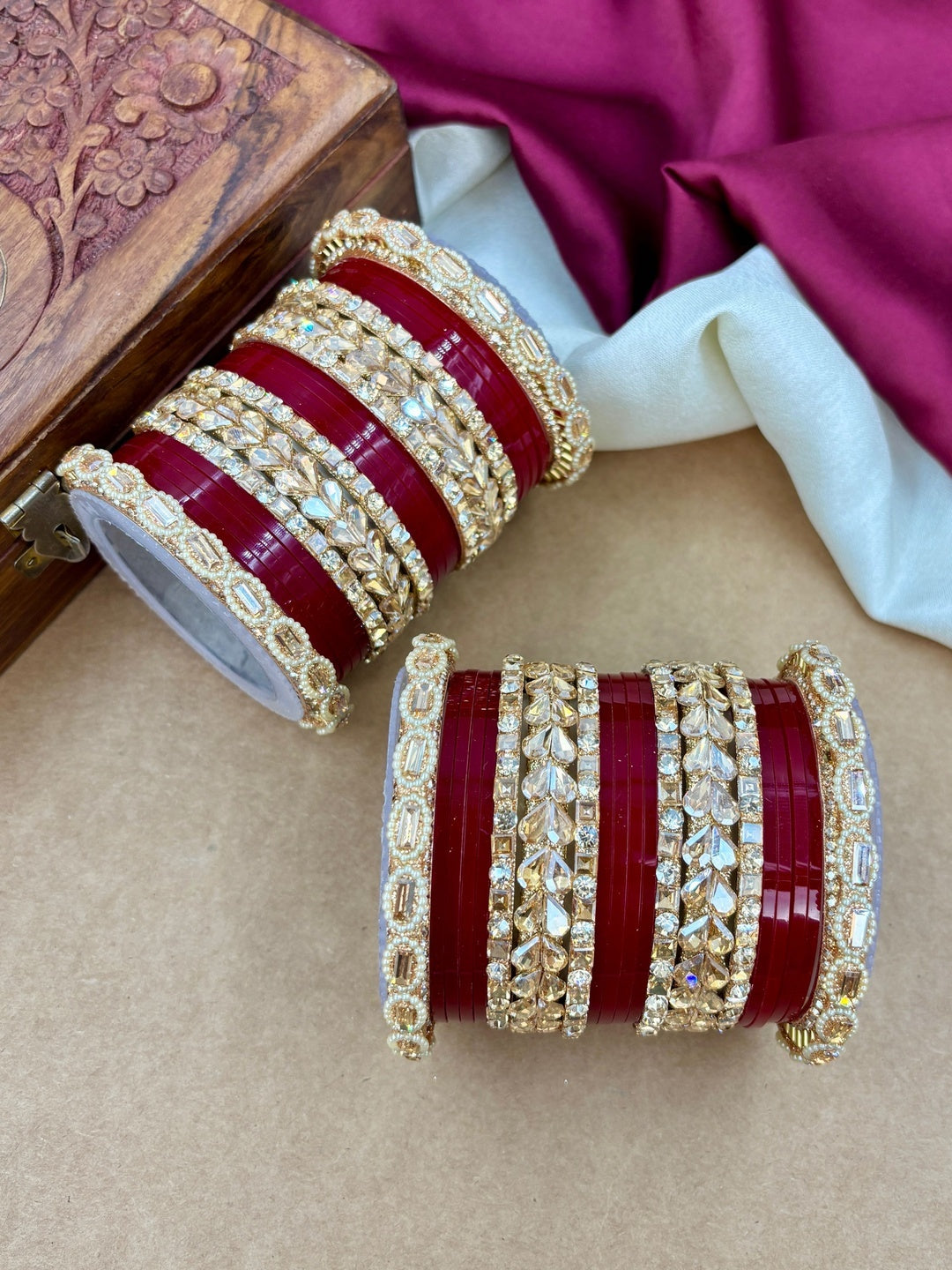Ishhaara Embellished Red Plastic Bangle Set - A stack of red plastic bangles adorned with intricate Kundan stone and pearl designs - view 3