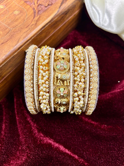 Ishhaara Gold Elephant Bangle Set - a stunning piece of jewelry featuring elephant motifs and intricate designs