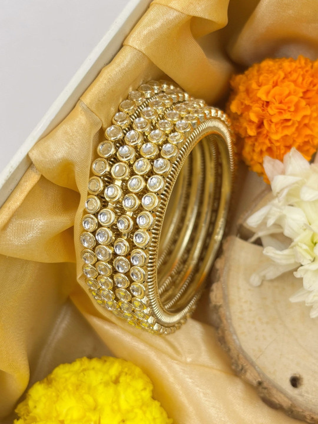 Ishhaara Gold Kundan Bangles - A pair of gold bangles with intricate Kundan work and sparkling stones - view 2