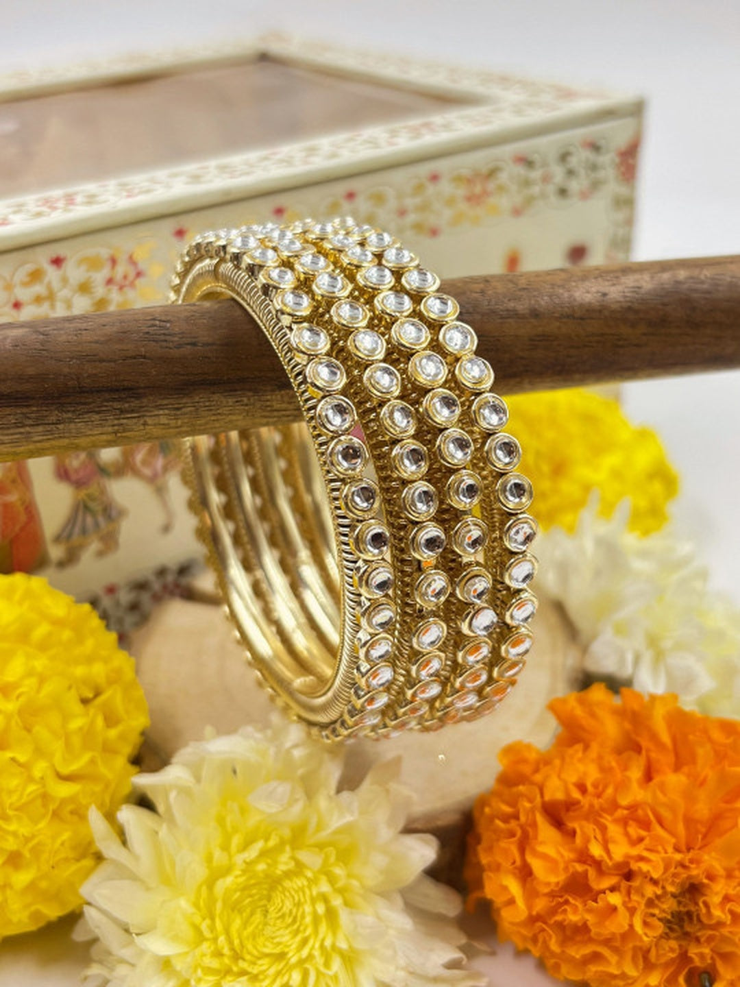 Ishhaara Gold Kundan Bangles - A pair of gold bangles with intricate Kundan work and sparkling stones - view 3