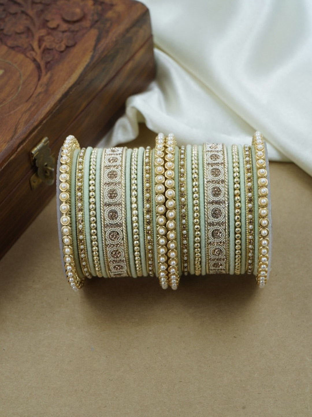 Ishhaara Green and Gold Embellished Bangle Set - a stack of green and gold bangles with pearl and velvet details - view 10