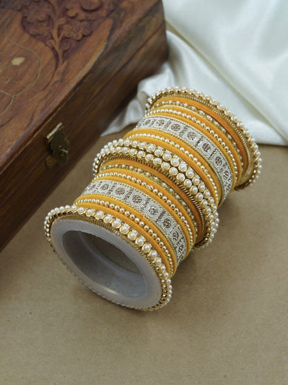 Ishhaara Green and Gold Embellished Bangle Set - a stack of green and gold bangles with pearl and velvet details - view 19