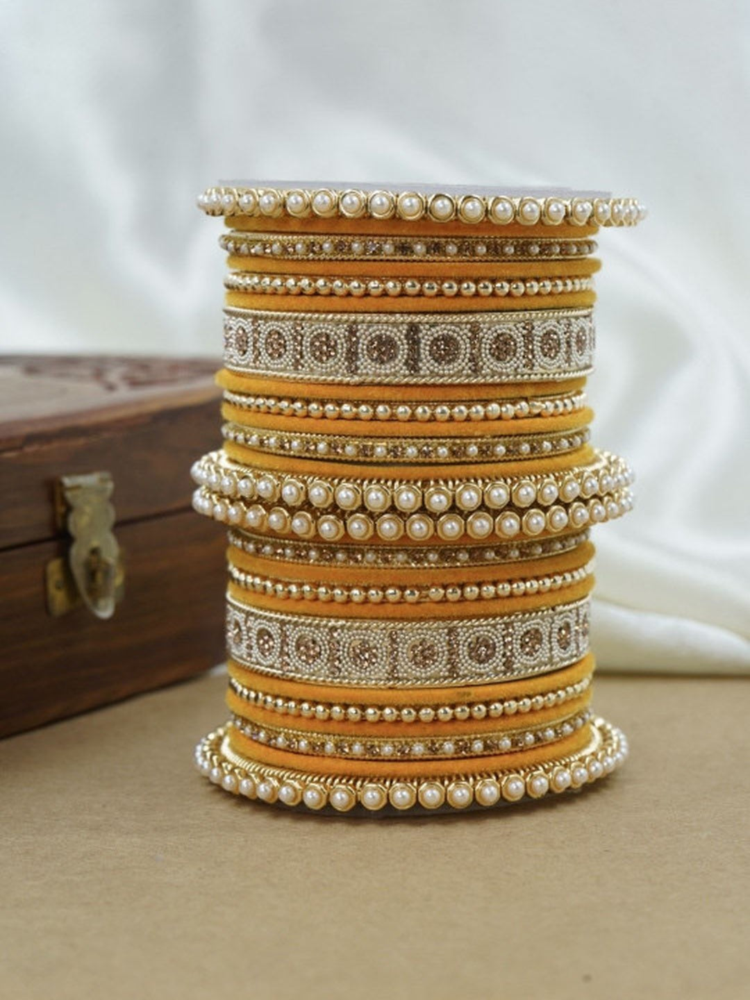 Ishhaara Green and Gold Embellished Bangle Set - a stack of green and gold bangles with pearl and velvet details - view 20