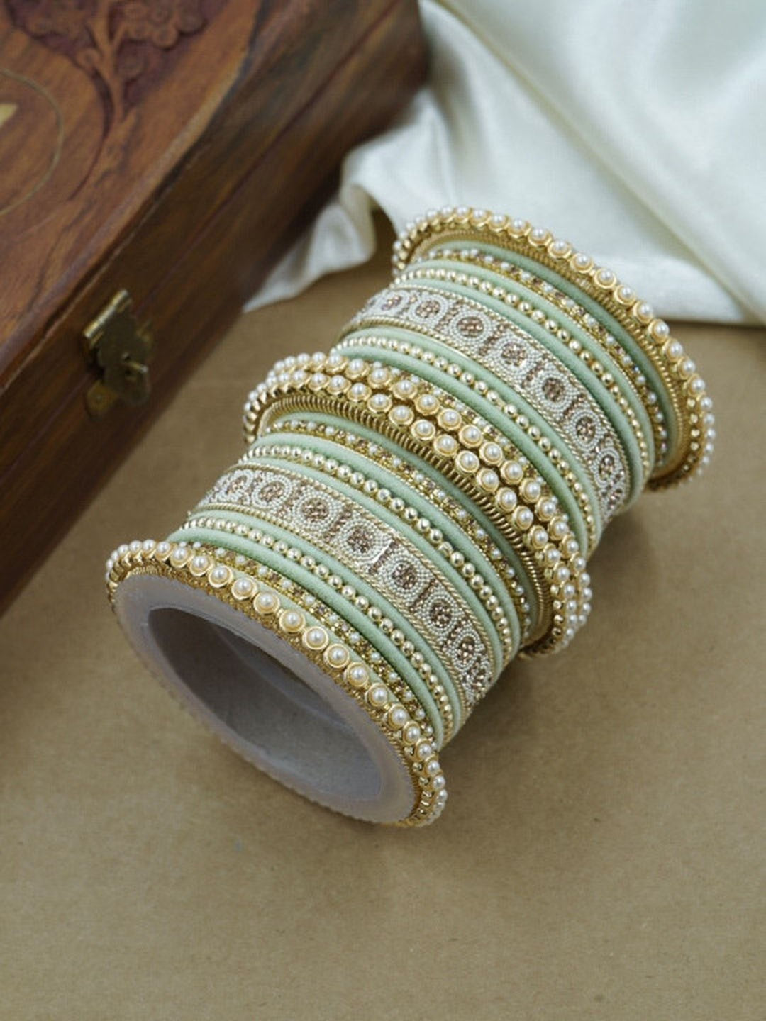 Ishhaara Green and Gold Embellished Bangle Set - a stack of green and gold bangles with pearl and velvet details - view 9