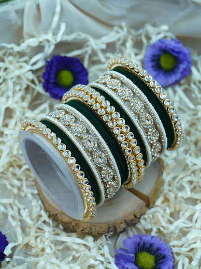 Ishhaara Green Velvet Kundan Bangles Set - a set of green and gold bangles with kundan stones on a wooden stand