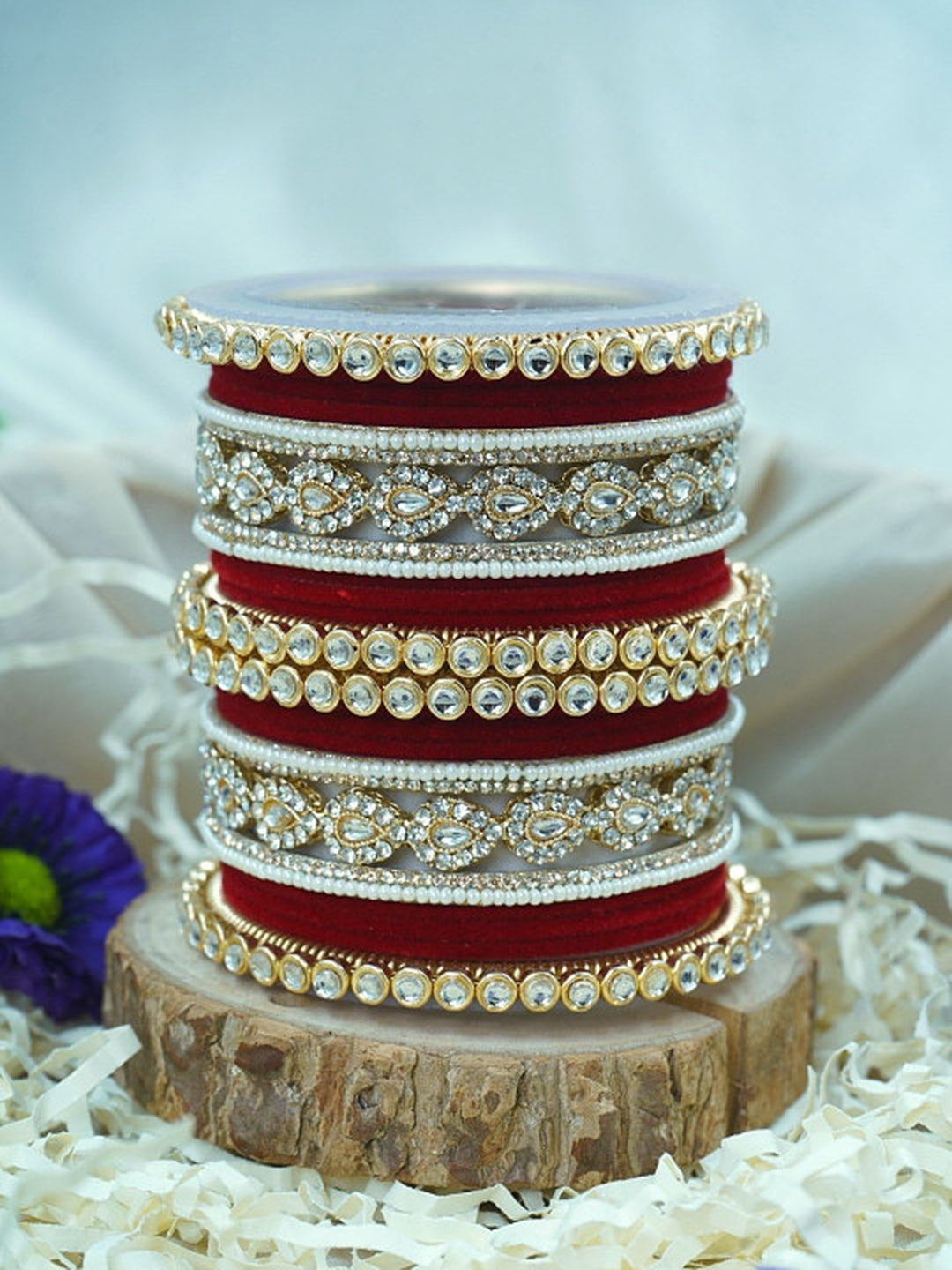 Ishhaara Green Velvet Kundan Bangles Set - a set of green and gold bangles with kundan stones on a wooden stand - view 13