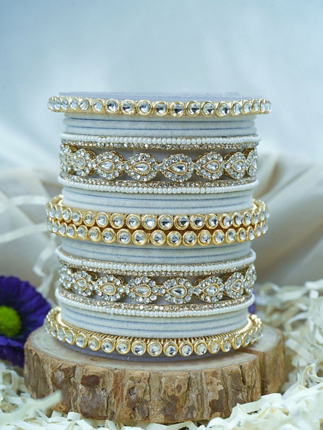 Ishhaara Green Velvet Kundan Bangles Set - a set of green and gold bangles with kundan stones on a wooden stand - view 15