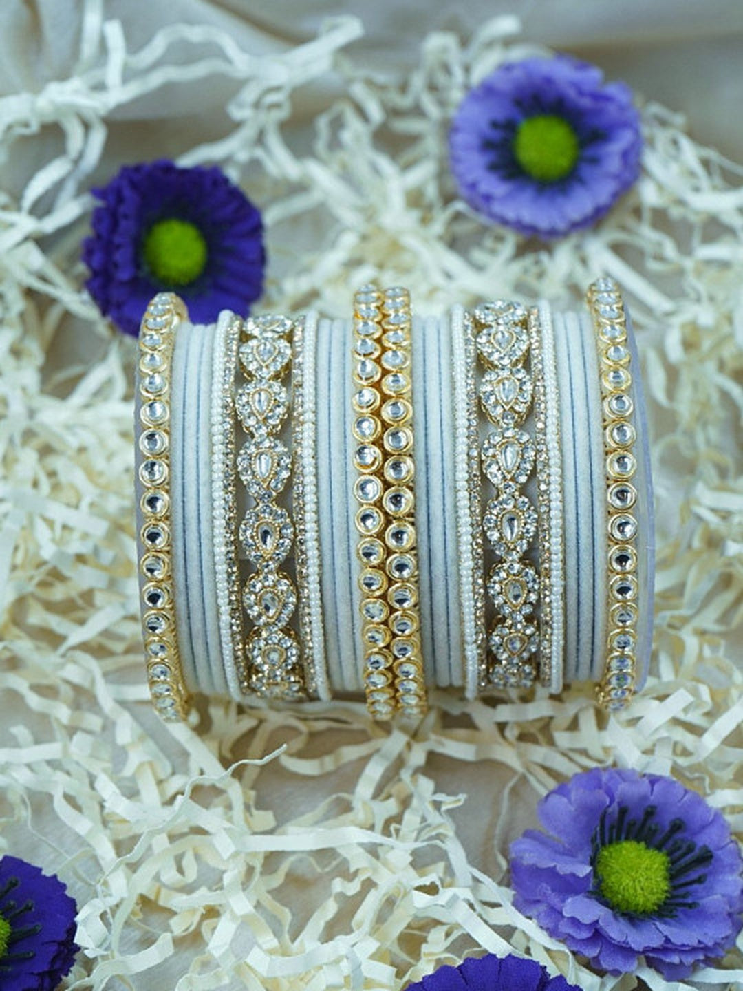 Ishhaara Green Velvet Kundan Bangles Set - a set of green and gold bangles with kundan stones on a wooden stand - view 16