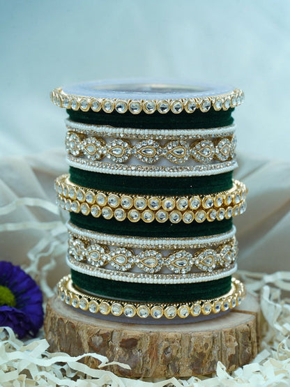 Ishhaara Green Velvet Kundan Bangles Set - a set of green and gold bangles with kundan stones on a wooden stand - view 2