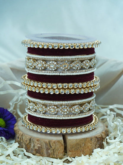 Ishhaara Green Velvet Kundan Bangles Set - a set of green and gold bangles with kundan stones on a wooden stand - view 3