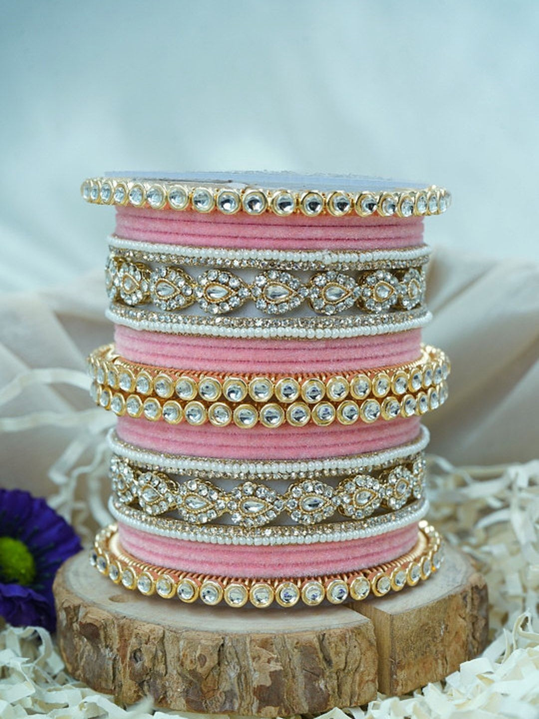 Ishhaara Green Velvet Kundan Bangles Set - a set of green and gold bangles with kundan stones on a wooden stand - view 6