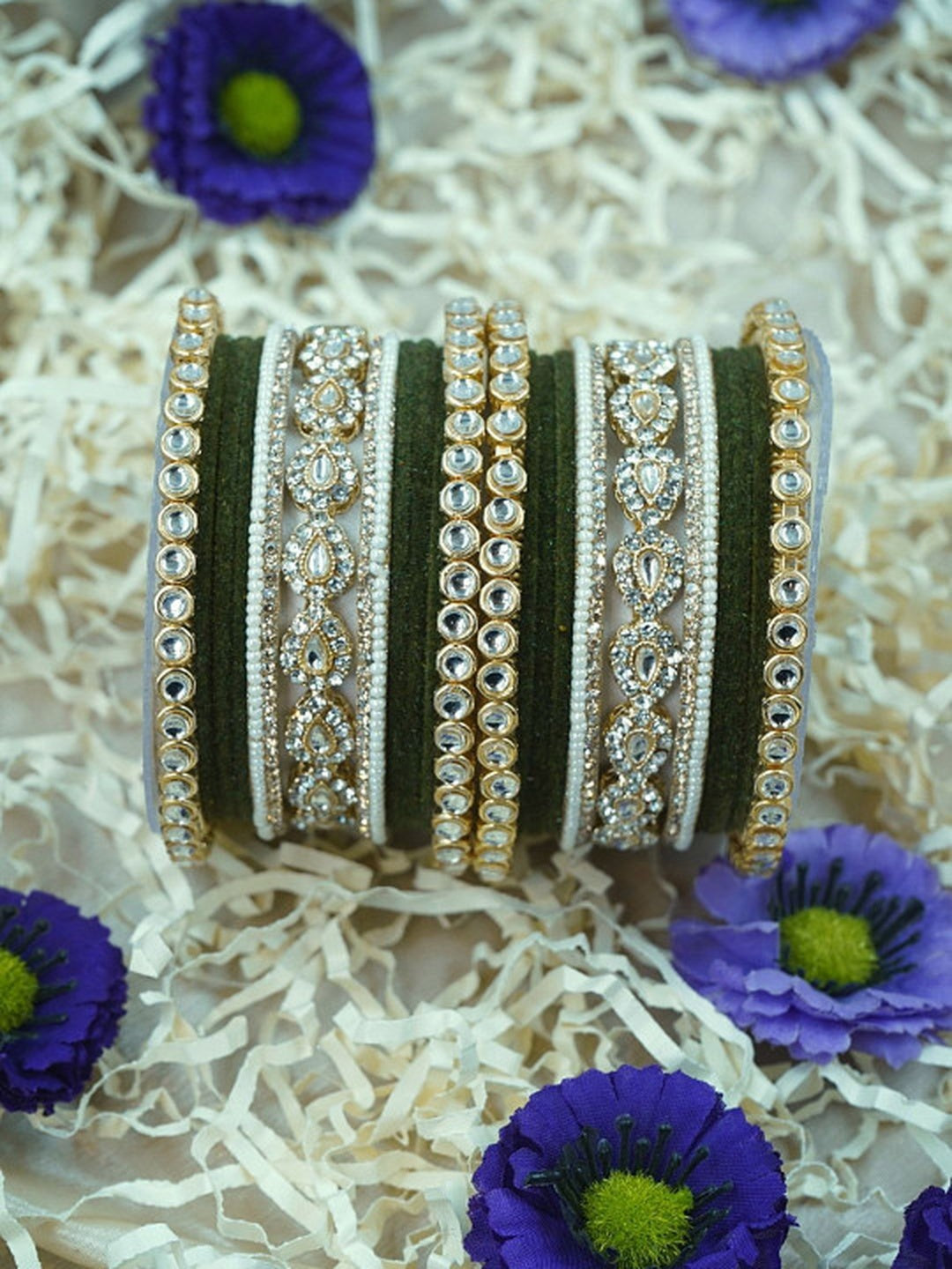 Ishhaara Green Velvet Kundan Bangles Set - a set of green and gold bangles with kundan stones on a wooden stand - view 7