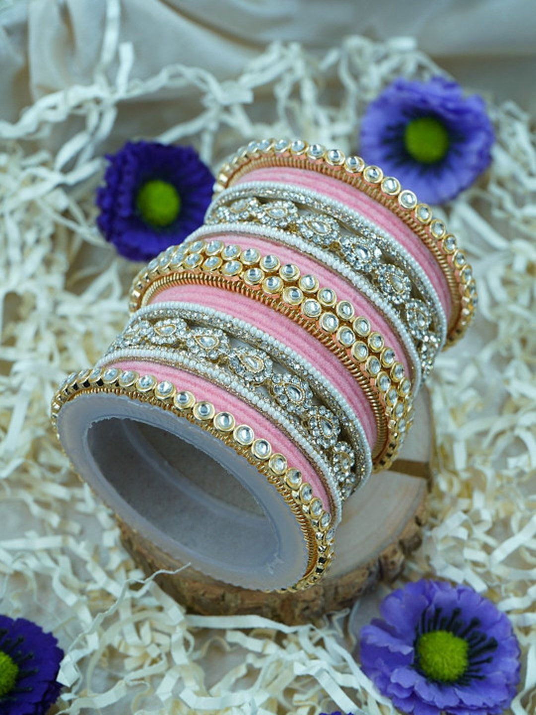 Ishhaara Green Velvet Kundan Bangles Set - a set of green and gold bangles with kundan stones on a wooden stand - view 9
