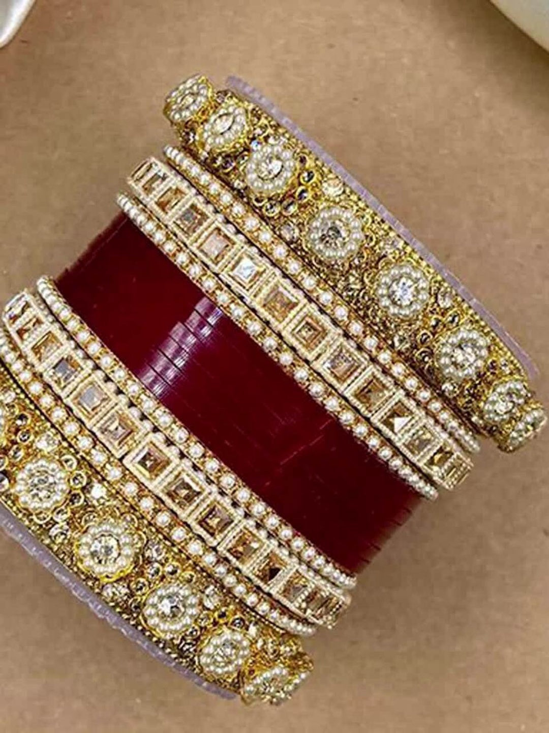 Ishhaara Handcrafted Kundan Bangles Set - a stack of intricately designed bangles with red glass center - view 9