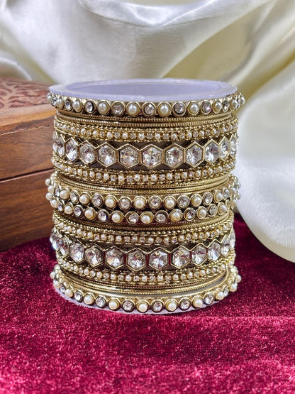 Ishhaara Kundan Bangle Set - a stack of intricately designed gold bangles with precious stones and pearls
