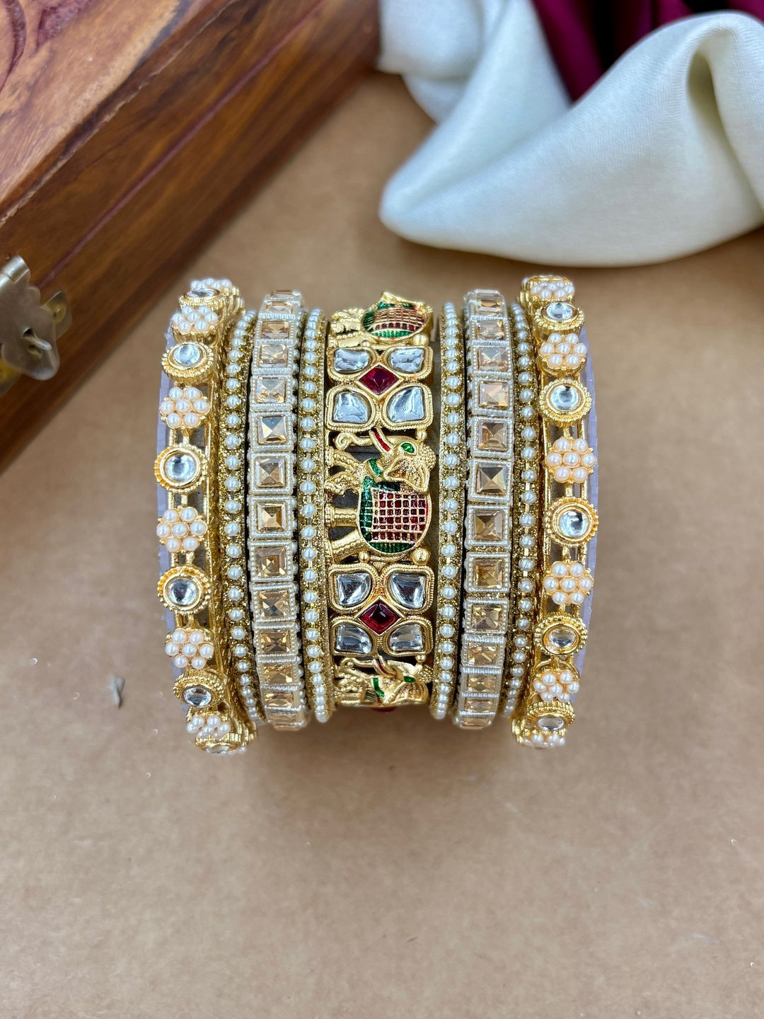 Ishhaara Kundan Bangle Set - A stunning collection of gold-plated bangles with Kundan work and pearls.