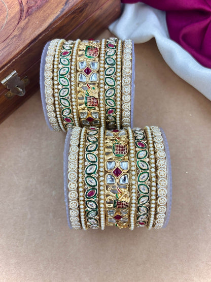 Ishhaara Kundan Bangle Set - A pair of intricately designed gold-plated bangles with kundan work and colorful stones.