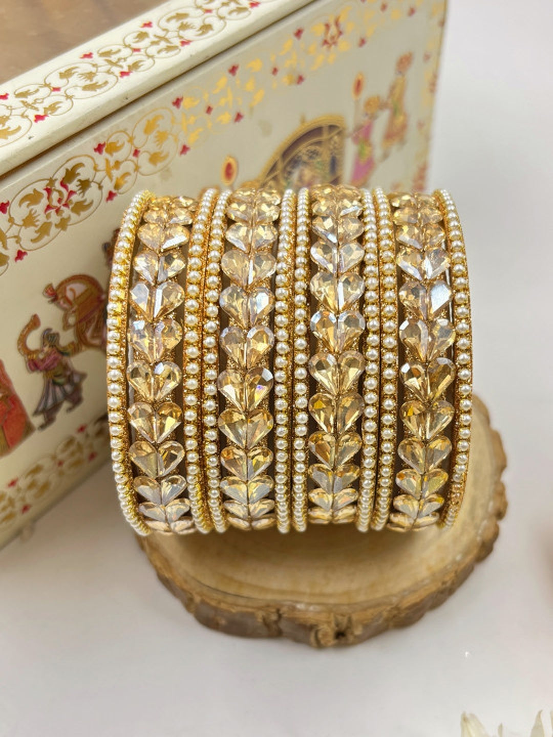 Ishhaara Kundan Bangle Set in Gold - traditional Indian jewelry on a wooden stand