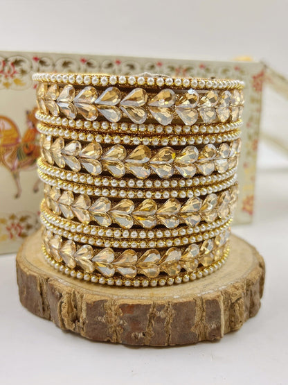 Ishhaara Kundan Bangle Set in Gold - traditional Indian jewelry on a wooden stand - view 2