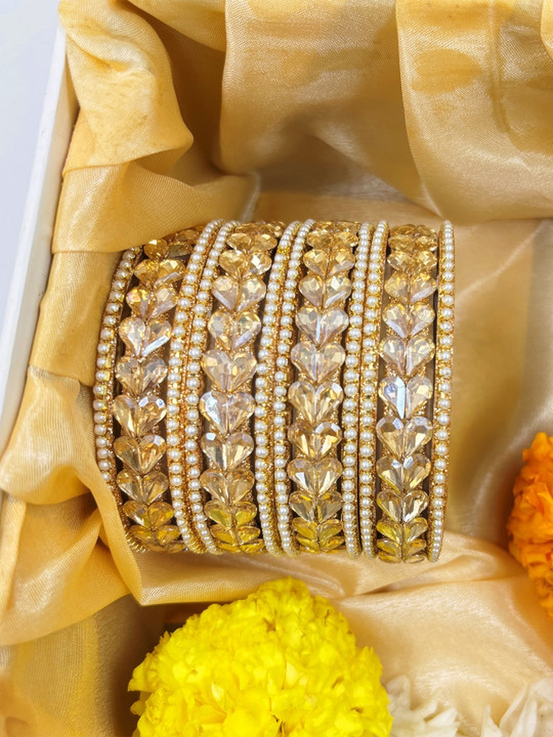 Ishhaara Kundan Bangle Set in Gold - traditional Indian jewelry on a wooden stand - view 3