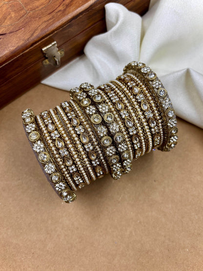 Ishhaara Kundan Bangles Set - A beautiful set of gold bangles adorned with stones and pearls