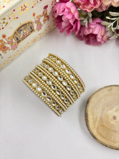 Ishhaara Kundan Gold Bangles - A close-up of intricately designed gold bangles adorned with stones. - view 2