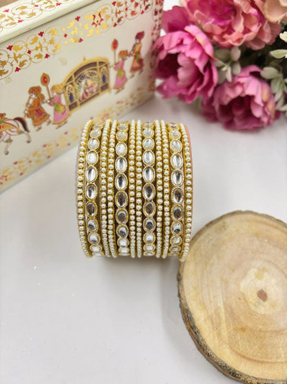 Ishhaara Kundan Gold Bangles - A close-up of intricately designed gold bangles adorned with stones. - view 3