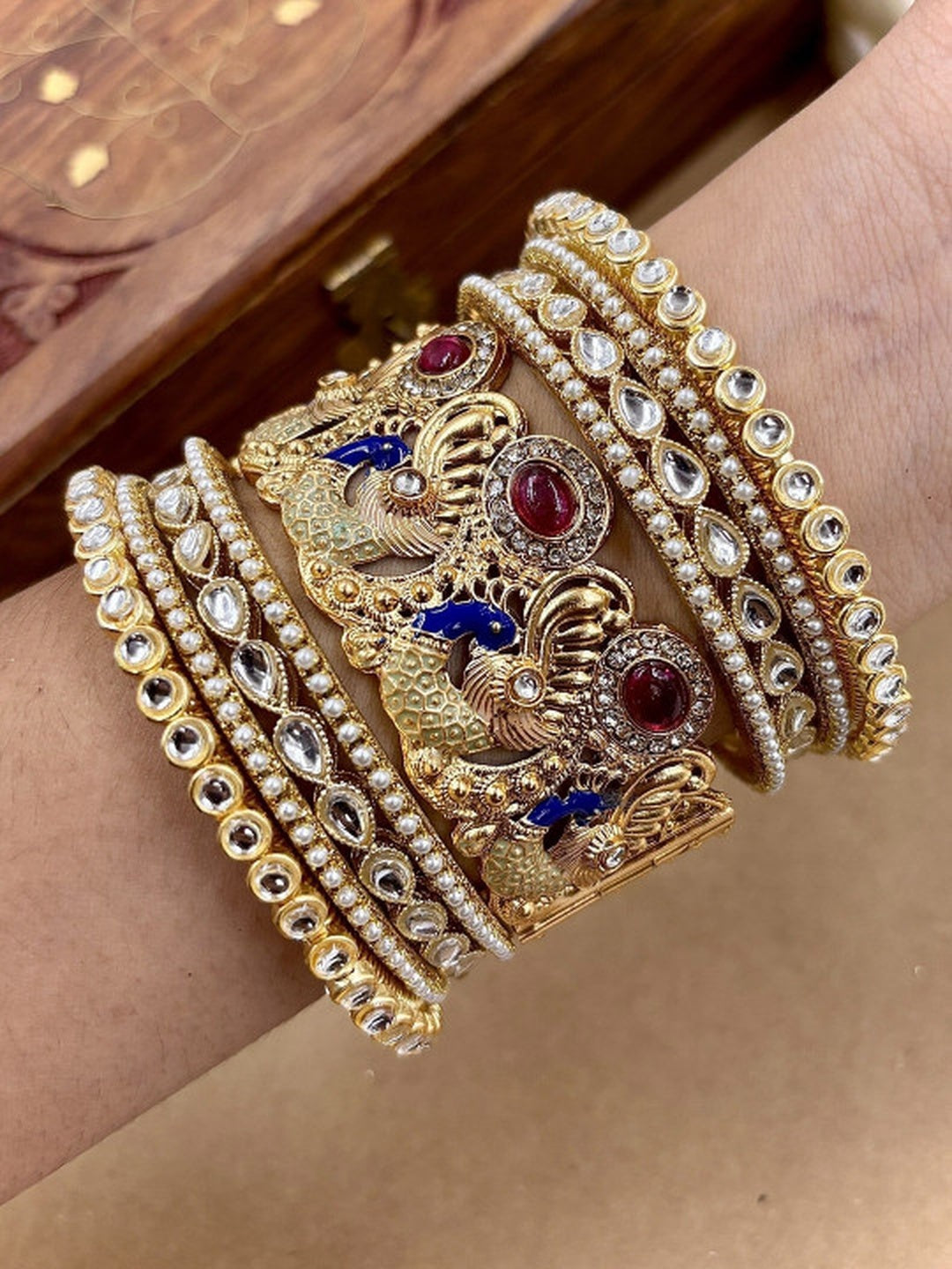 Ishhaara Kundan Peacock Bangle - A stunning gold bangle adorned with kundan and polki stones, featuring a peacock design.