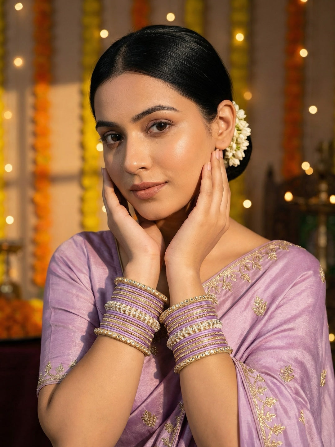 Ishhaara Lavender Embellished Silk Sari - A woman wearing a lavender sari with gold embroidery and traditional Indian jewelry