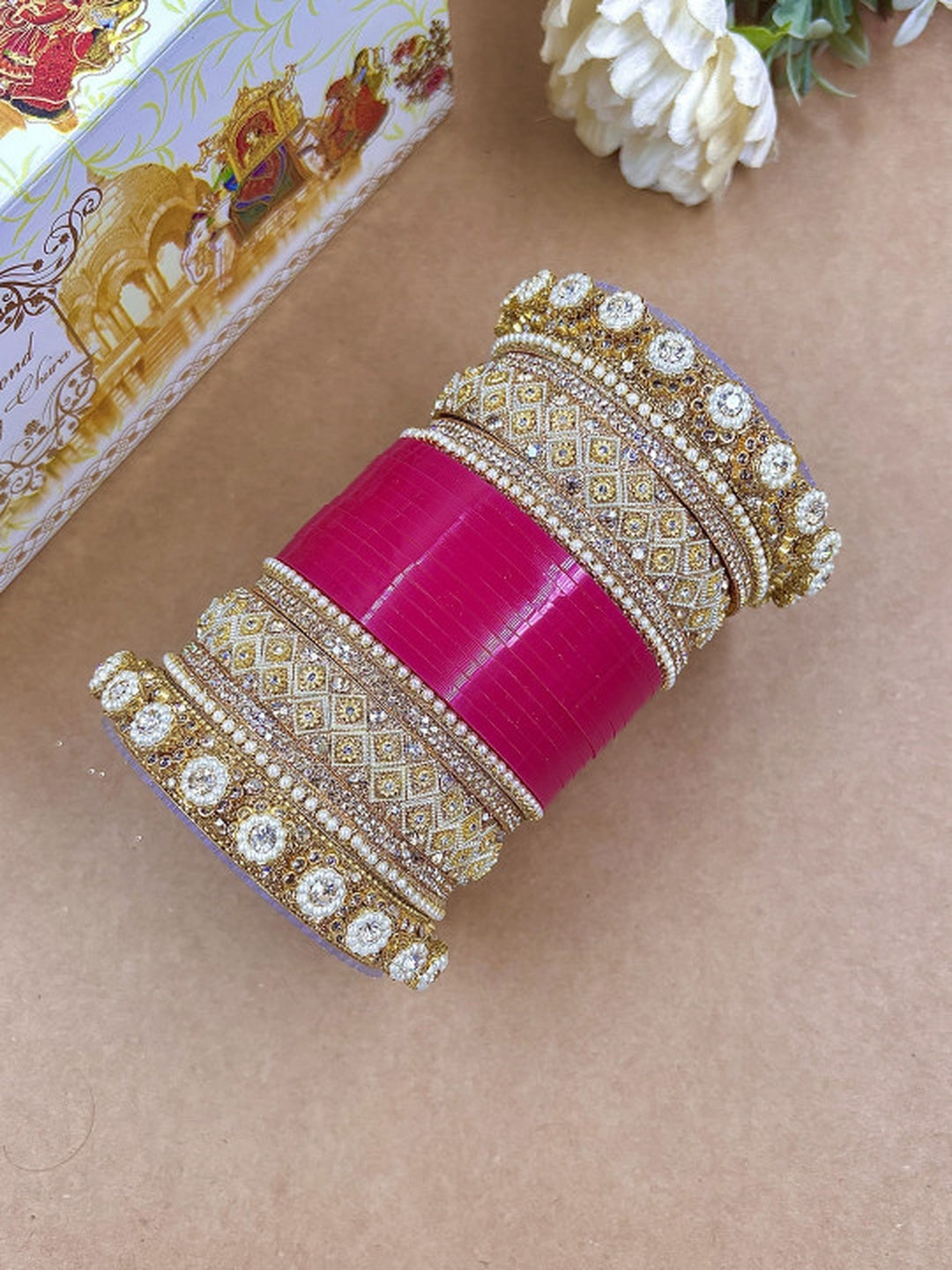 Ishhaara Luxury Pink Kundan Bangle Set - a stack of pink and gold bangles with intricate designs