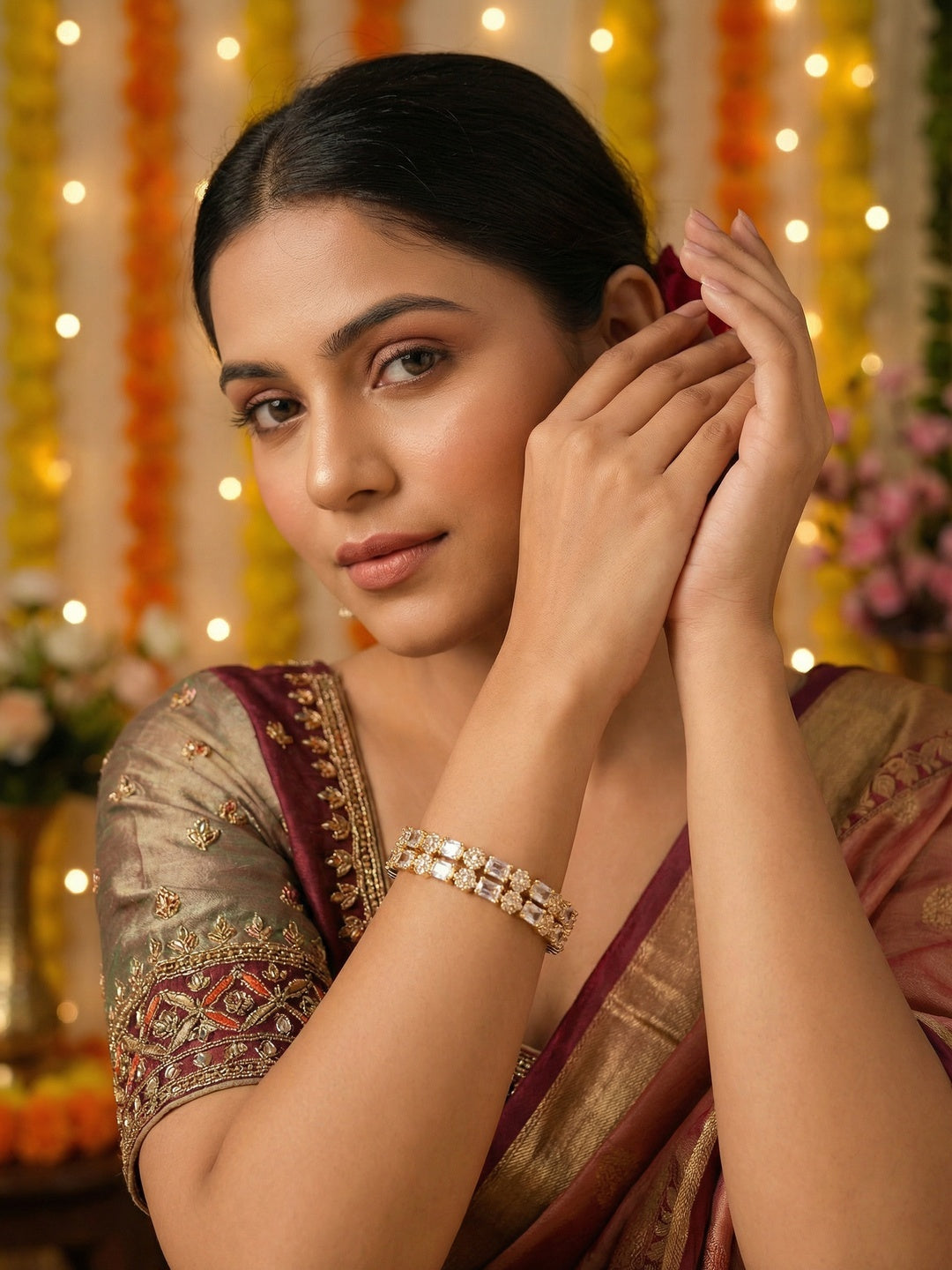 Ishhaara Maroon Embellished Saree - A woman wearing a maroon saree with gold border and intricate hand embroidery