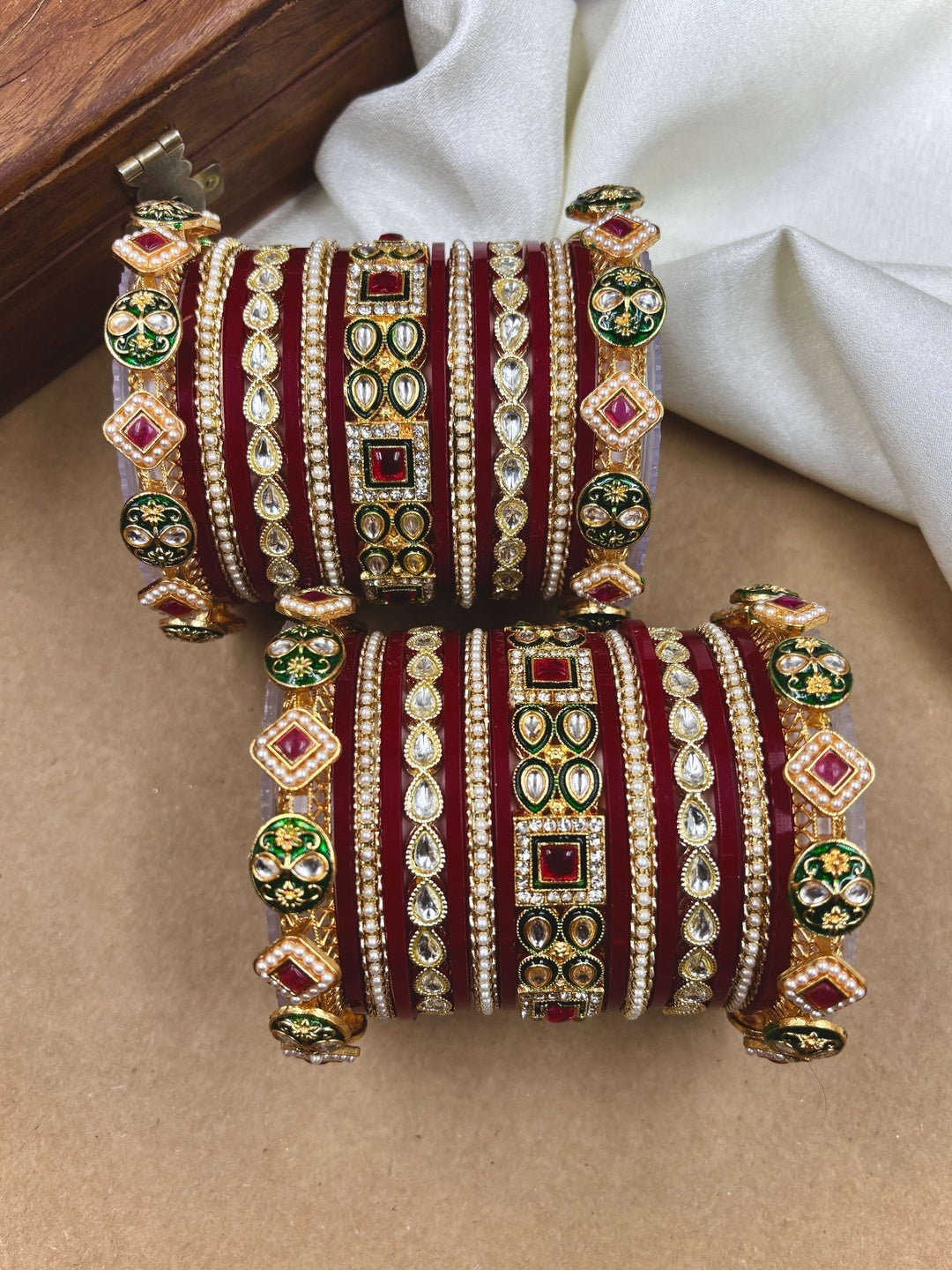 Ishhaara Maroon Kundan Bangle Set - a woman wearing a maroon top and gold kundan bangles - view 3