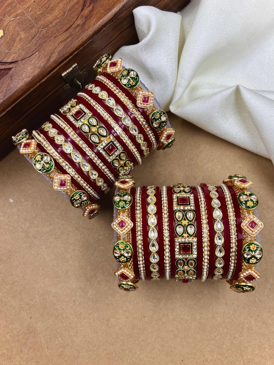 Ishhaara Maroon Kundan Bangle Set - a woman wearing a maroon top and gold kundan bangles - view 4