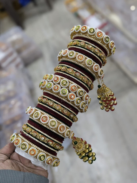 the brand Meenakari Lac Bangles Set with Kundan work