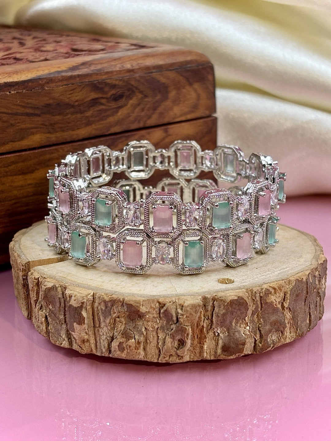 Ishhaara Multi Color CZ Kundan Bracelet - elegant silver bracelet with multi-color CZ stones on a wooden display