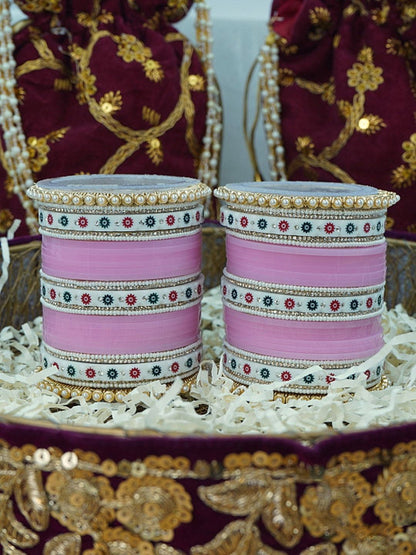 Ishhaara Pink Bangle Set - a beautifully crafted set of pink bangles with pearl embellishments arranged in a decorative bowl with shredded paper - view 3