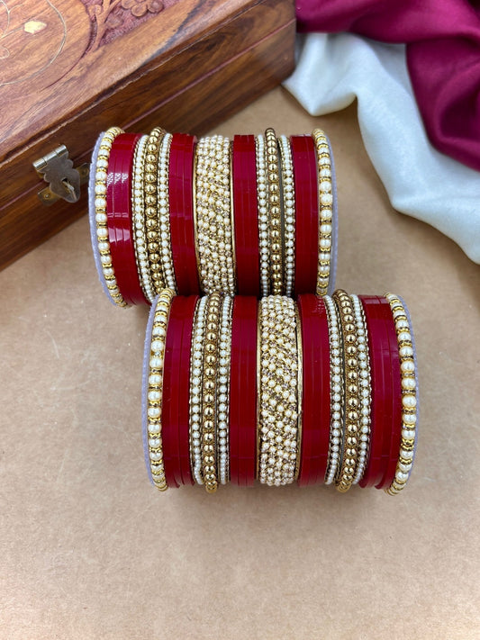 Ishhaara Red and Gold Bangle Set - a stack of red and gold bangles with pearl details