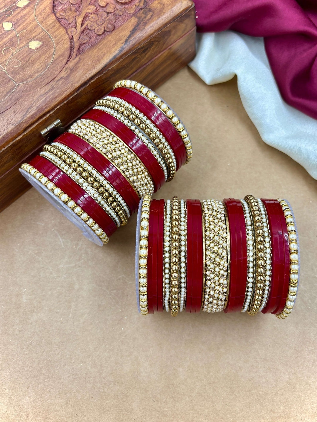 Ishhaara Red and Gold Bangle Set - a stack of red and gold bangles with pearl details - view 2