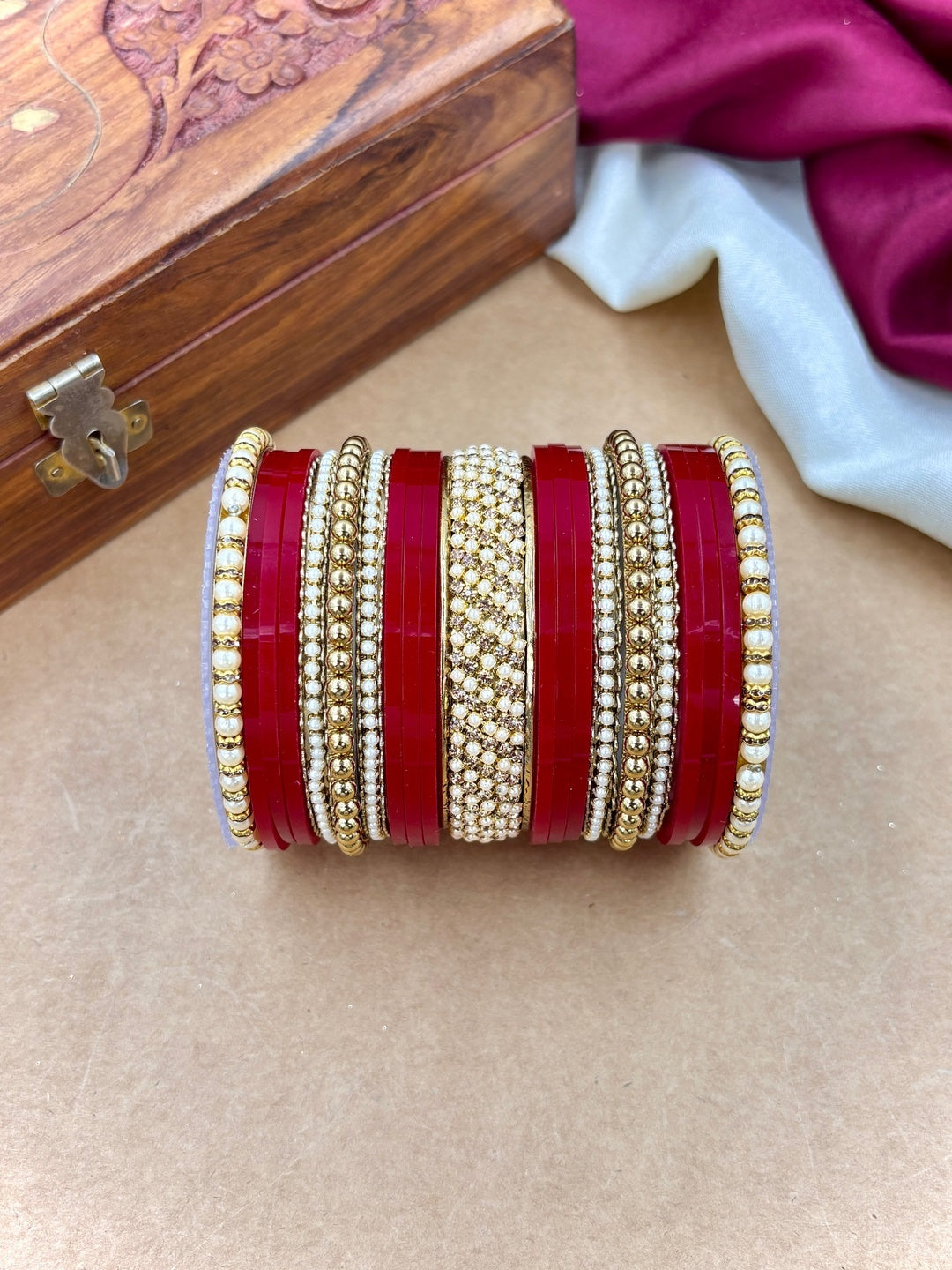 Ishhaara Red and Gold Bangle Set - a stack of red and gold bangles with pearl details - view 3