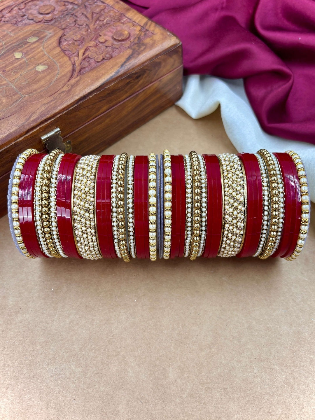 Ishhaara Red and Gold Bangle Set - a stack of red and gold bangles with pearl details - view 5