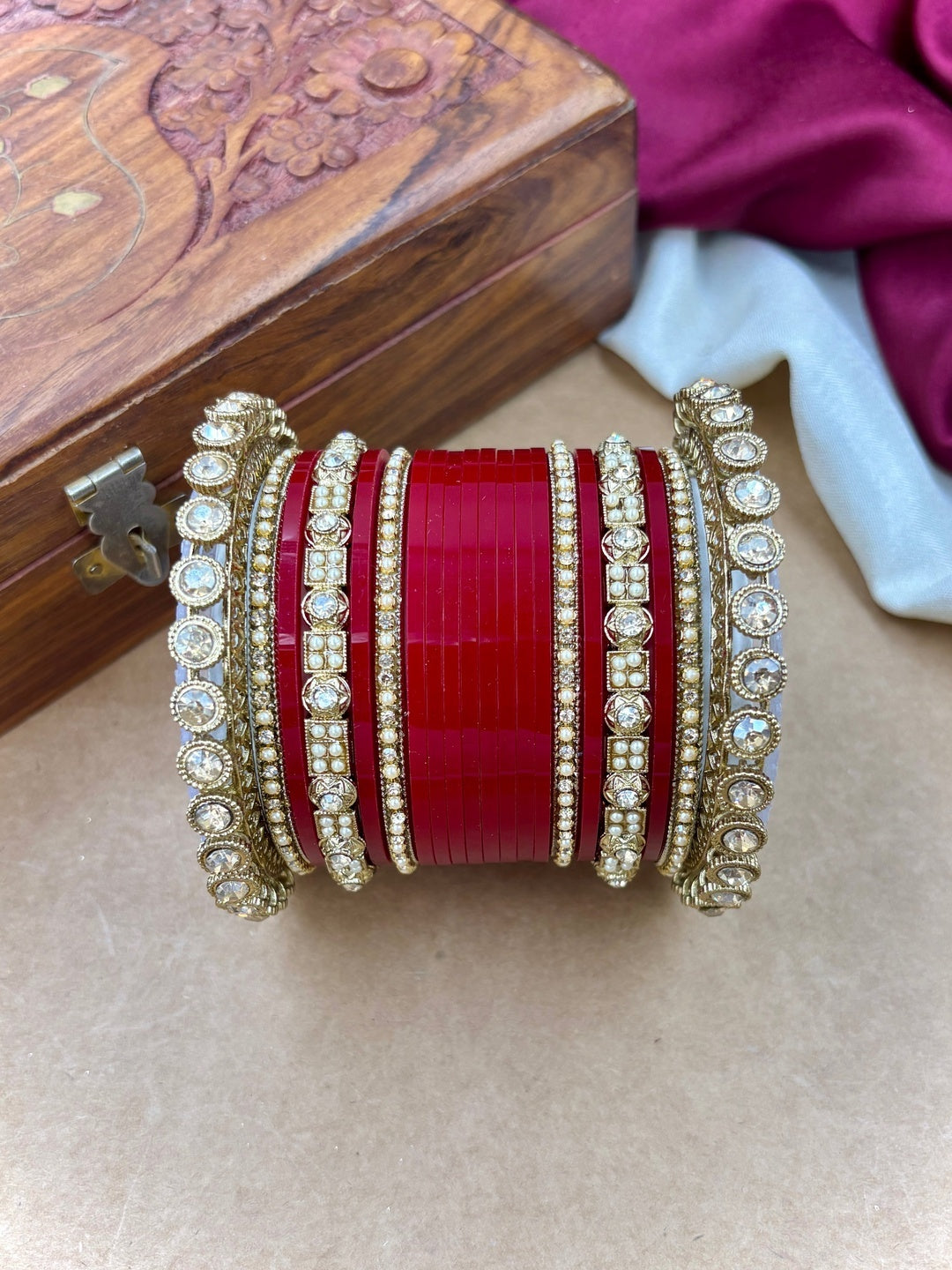 Ishhaara Red Kundan Bangle Set - a collection of red and gold bangles with intricate designs and stones - view 4