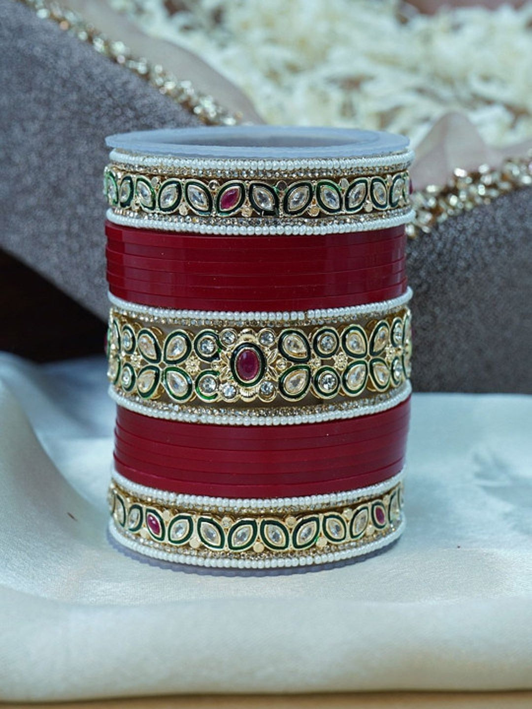 Ishhaara Red Kundan Bangle Set - a stack of red and gold bangles with intricate Kundan designs
