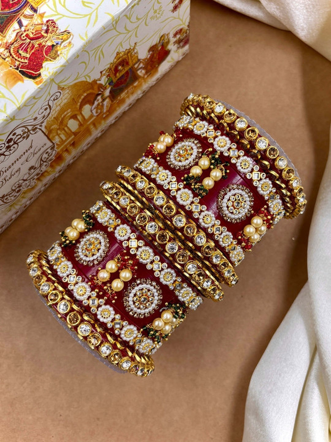 Ishhaara Red Kundan Bangle Set - a stack of intricately designed red and gold bangles - view 3