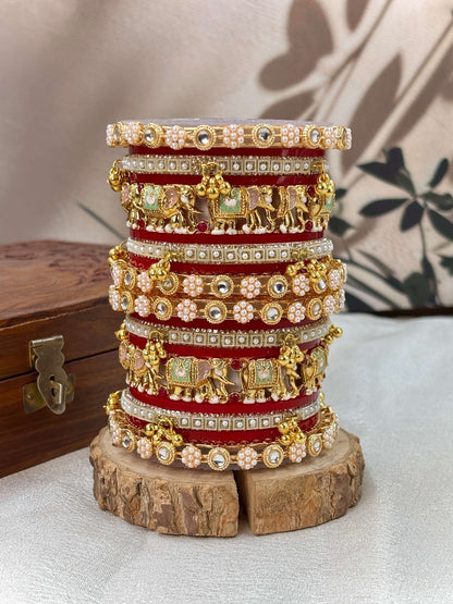 Ishhaara Traditional Gold Kundan Bangles Set - a stack of intricately designed red and gold bangles with elephant motifs - view 3