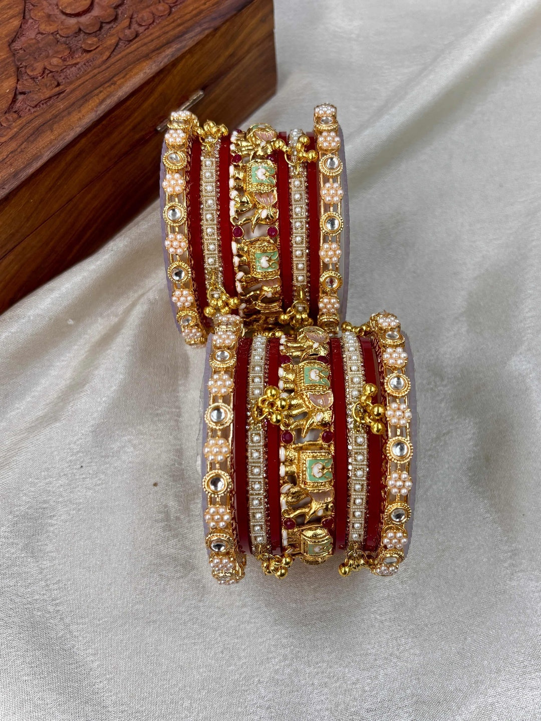 Ishhaara Traditional Gold Kundan Bangles Set - a stack of intricately designed red and gold bangles with elephant motifs - view 4