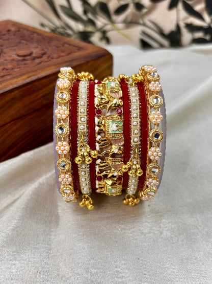 Ishhaara Traditional Gold Kundan Bangles Set - a stack of intricately designed red and gold bangles with elephant motifs - view 5
