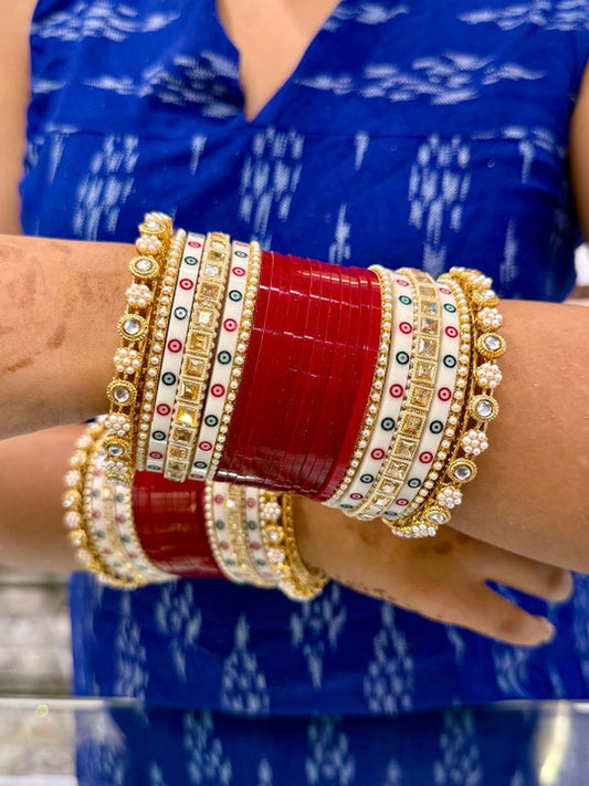 Ishhaara Traditional Indian Kundan Bangle Set - A woman wearing a blue top showcasing red and gold bangles